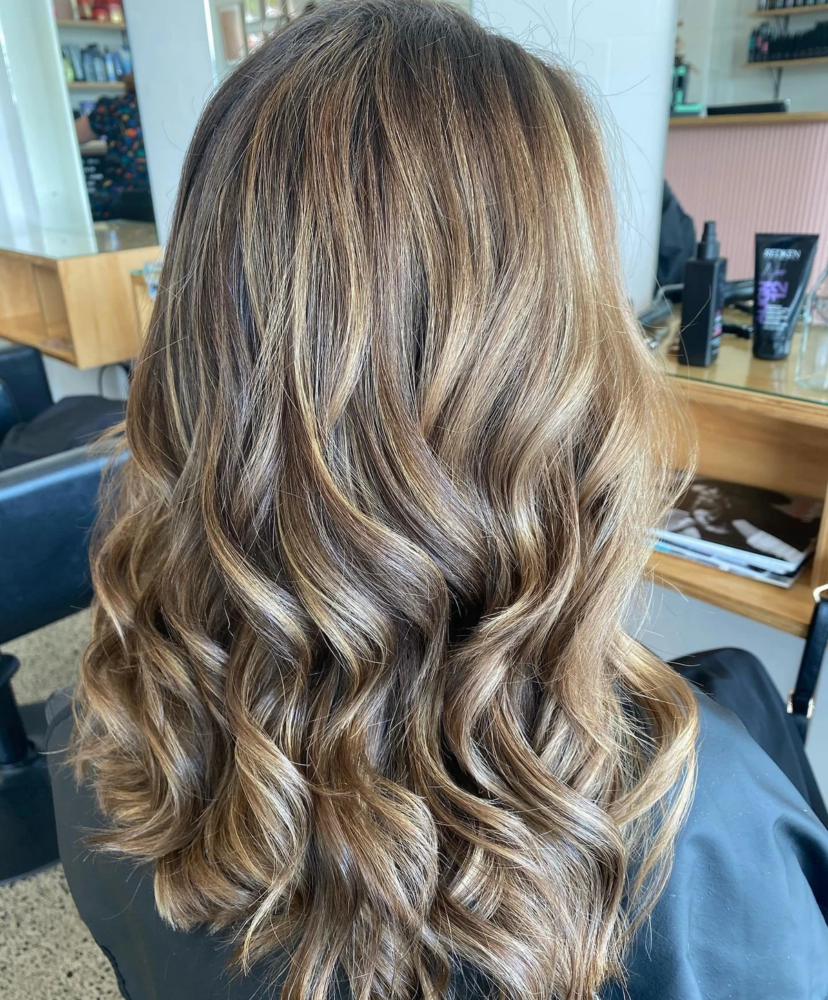 Dimensional, softly waved hair created at Meraki Hair Studio